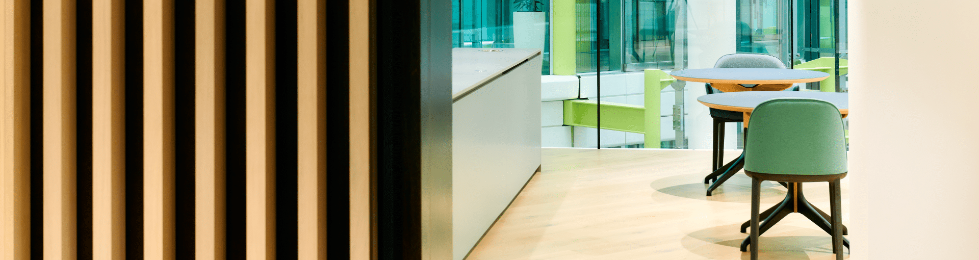 Green chairs and a wooden room divider